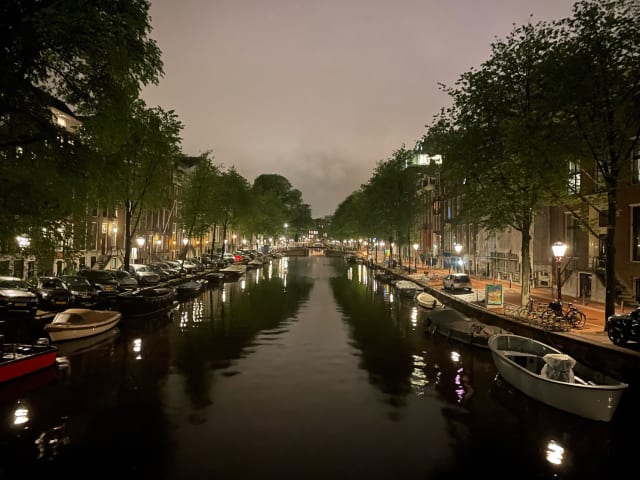 Canal lights in Amsterdam during the evening.